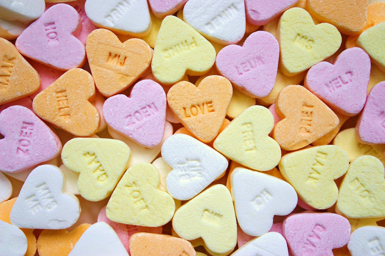 Home Colorful heart-shaped candies with embossed love messages, perfect for romance themes.